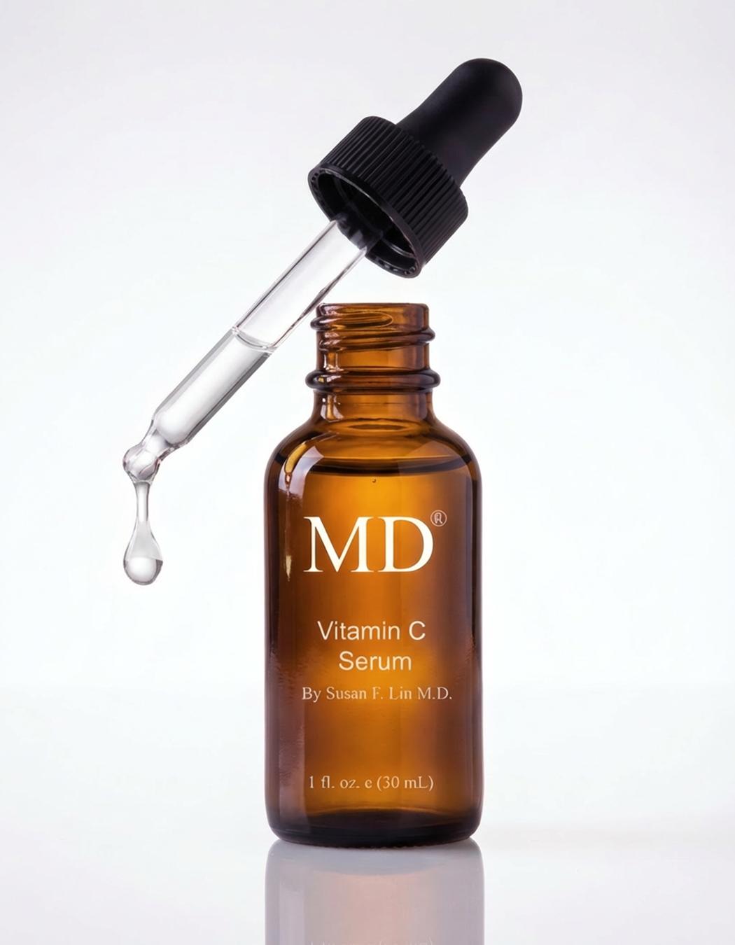 Close-up of MD Ultimate Vitamin C Serum showing a crystal-clear, non-oxidized dropper to demonstrate formula stability and weightless water-based texture.